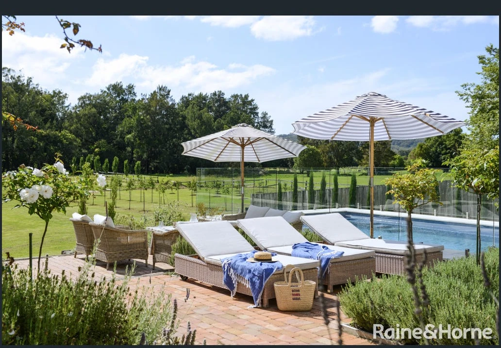 Murrayville pool garden with striped umbrellas and mature planting