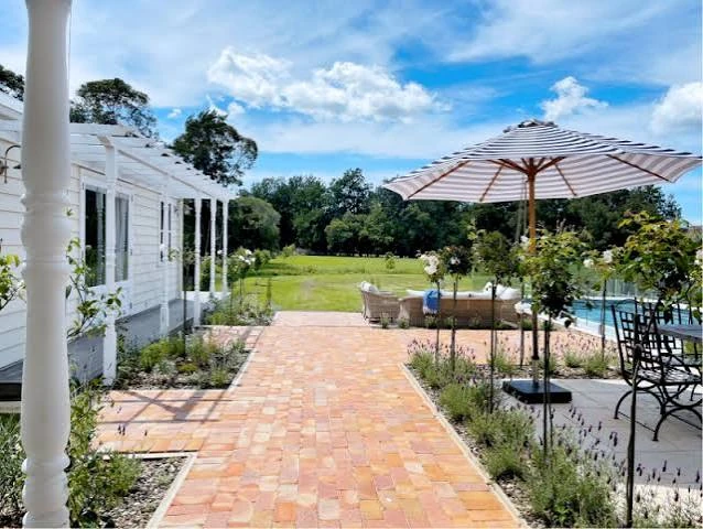 Brick terrace, standard roses and garden beside the Murrayville pool